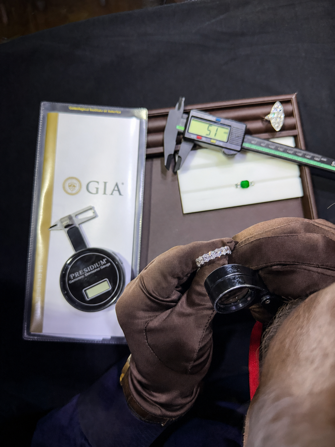 Konstantin Kupfer inspecting a diamond ring at his jewelry bench